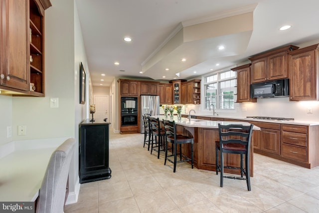 kitchen featuring open shelves, black appliances, recessed lighting, a breakfast bar area, and ornamental molding