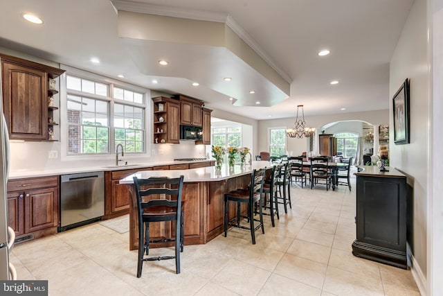 kitchen featuring appliances with stainless steel finishes, open shelves, recessed lighting, a sink, and a kitchen island