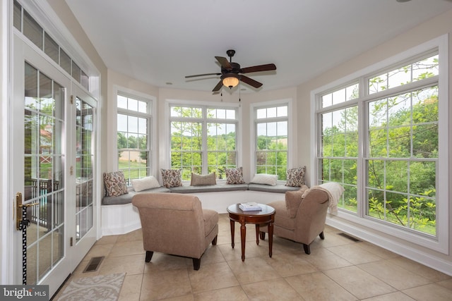 sunroom featuring french doors and tile patterned flooring