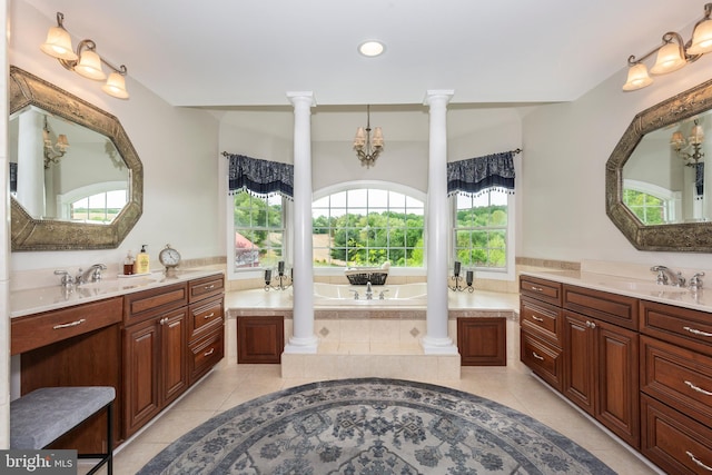 bathroom with decorative columns, tile patterned floors, two vanities, recessed lighting, and a bath