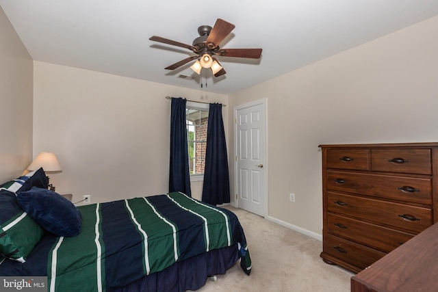 bedroom with light carpet, baseboards, and a ceiling fan