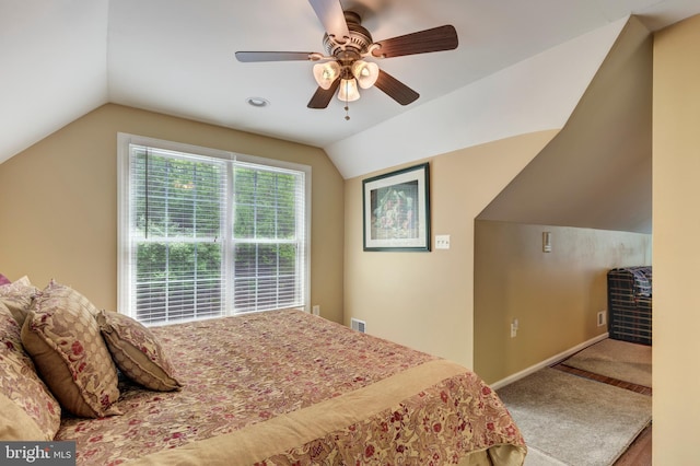 carpeted bedroom featuring vaulted ceiling, a ceiling fan, and baseboards