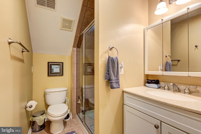 bathroom featuring toilet, a shower stall, vanity, and tile patterned floors