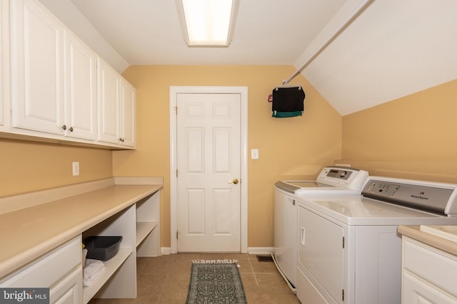 laundry room with separate washer and dryer, cabinet space, baseboards, and light tile patterned flooring