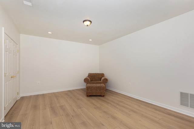 unfurnished room with light wood-type flooring, baseboards, and recessed lighting