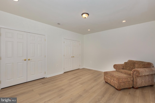 unfurnished room with light wood-style floors, baseboards, and recessed lighting