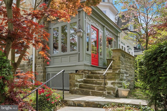 view of exterior entry featuring stone siding
