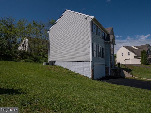 73 Marblehead Rd, Inwood, WV 25428 - view of side of property with an attached garage, a yard, driveway, and brick siding