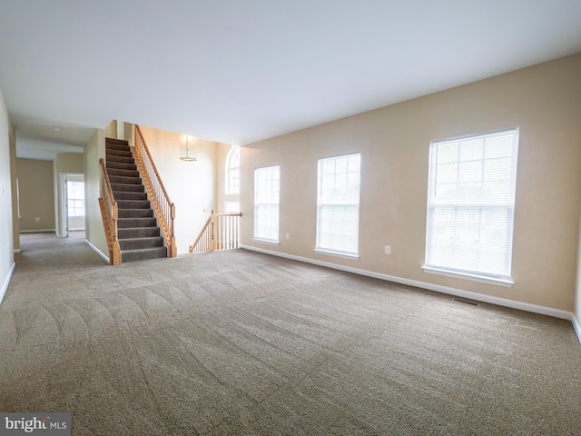 73 Marblehead Rd, Inwood, WV 25428 - unfurnished living room with baseboards, carpet flooring, and stairs