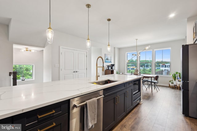 2627 Loganberry Dr, Herndon, VA 20171 - kitchen with a sink, stainless steel dishwasher, freestanding refrigerator, a chandelier, and hanging light fixtures