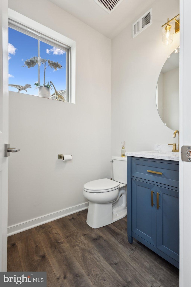 2627 Loganberry Dr, Herndon, VA 20171 - bathroom with toilet, wood finished floors, vanity, and baseboards