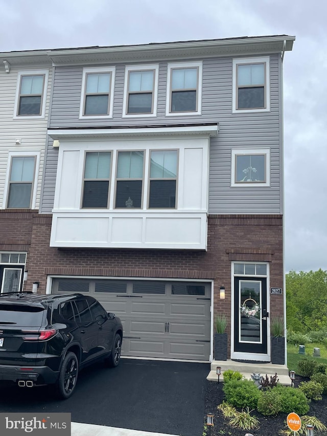2627 Loganberry Dr, Herndon, VA 20171 - view of property with brick siding, a garage, and asphalt driveway