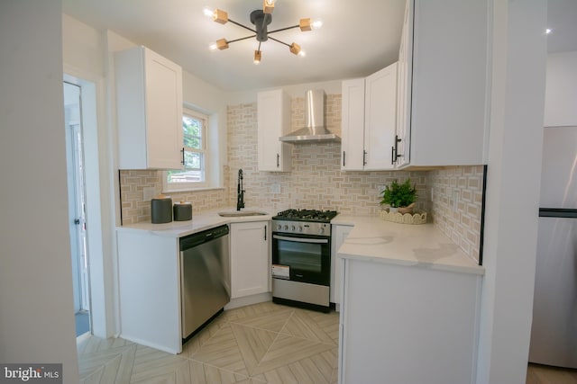 5446 Varnum St, Bladensburg, MD 20710 - kitchen with wall chimney range hood, stainless steel appliances, a sink, a chandelier, and tasteful backsplash
