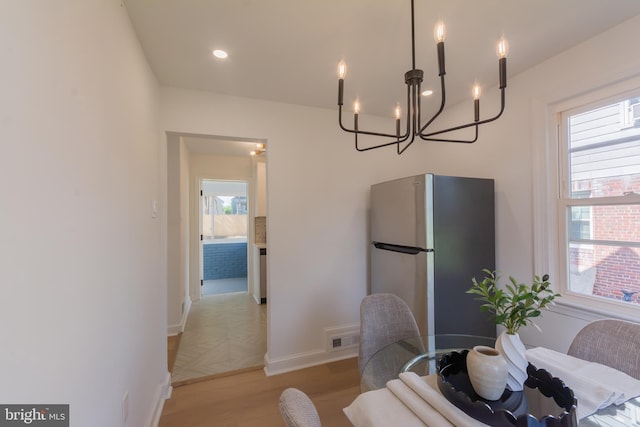 5446 Varnum St, Bladensburg, MD 20710 - dining space with a chandelier, plenty of natural light, baseboards, and light wood-style flooring