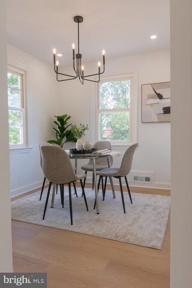 5446 Varnum St, Bladensburg, MD 20710 - dining area featuring a chandelier, wood finished floors, and baseboards