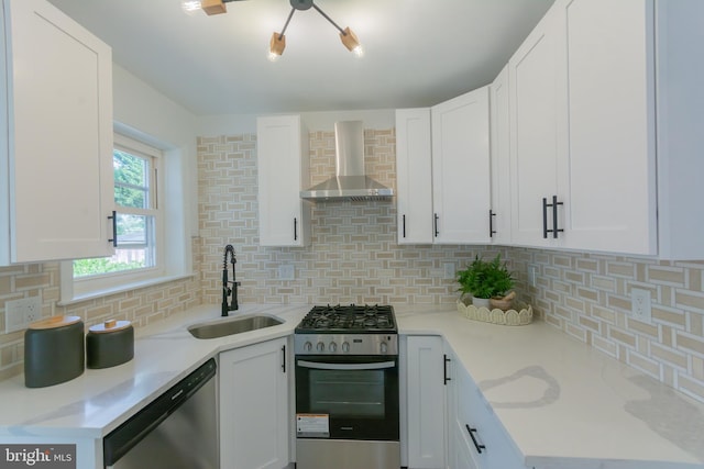 5446 Varnum St, Bladensburg, MD 20710 - kitchen with appliances with stainless steel finishes, wall chimney range hood, a sink, tasteful backsplash, and white cabinets
