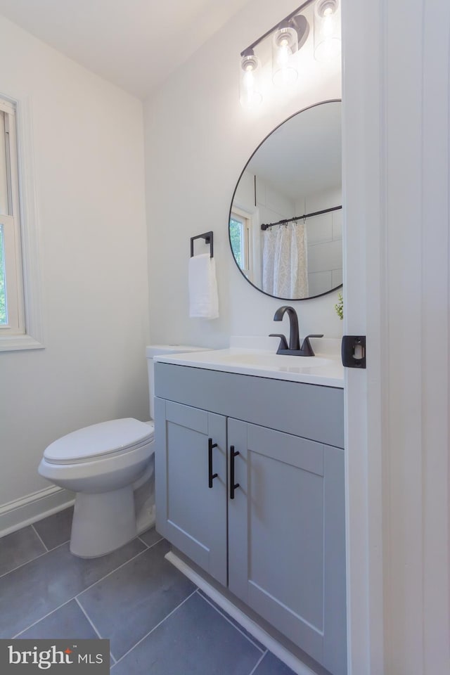 5446 Varnum St, Bladensburg, MD 20710 - bathroom with vanity, toilet, tile patterned flooring, and baseboards