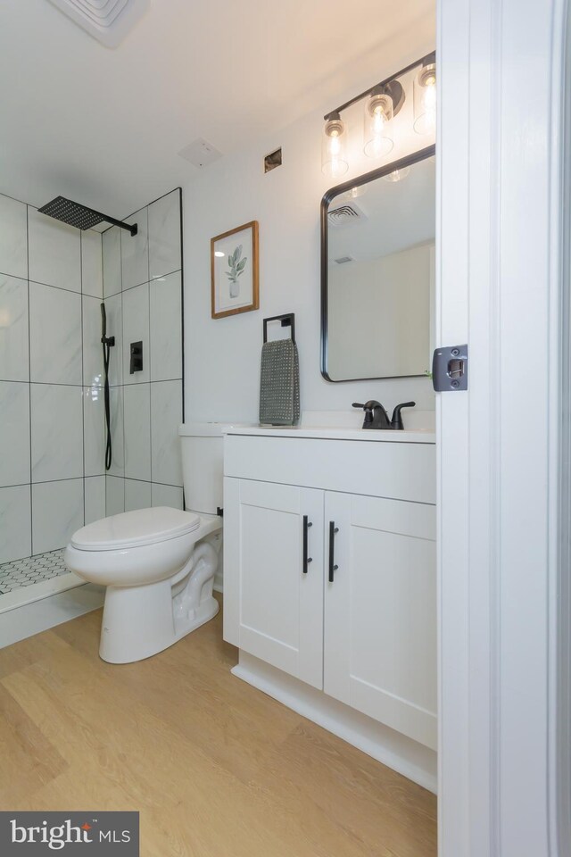 5446 Varnum St, Bladensburg, MD 20710 - bathroom with toilet, a tile shower, vanity, and wood finished floors