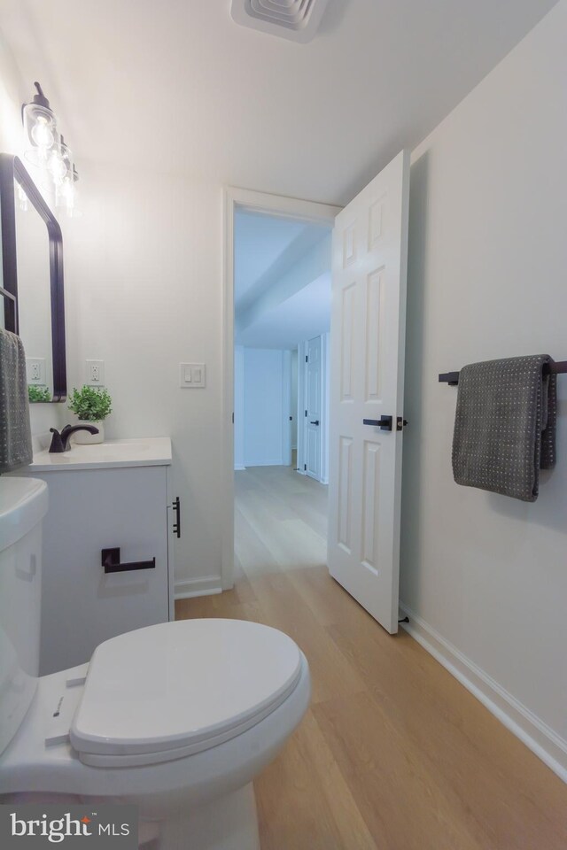 5446 Varnum St, Bladensburg, MD 20710 - bathroom with toilet, wood finished floors, vanity, and baseboards