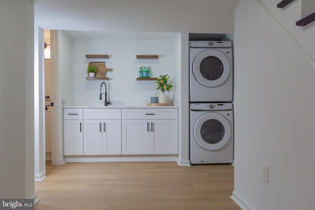 5446 Varnum St, Bladensburg, MD 20710 - laundry room with stacked washing machine and dryer, wet bar, light wood-type flooring, and baseboards