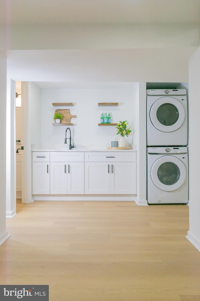 5446 Varnum St, Bladensburg, MD 20710 - laundry room featuring stacked washing machine and dryer, light wood finished floors, and baseboards