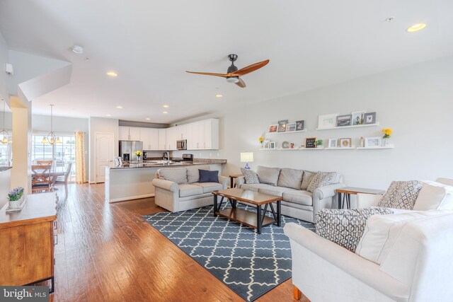 living room featuring a ceiling fan, dark wood-style floors, and recessed lighting