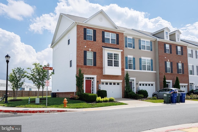multi unit property featuring driveway, a garage, brick siding, and central AC unit