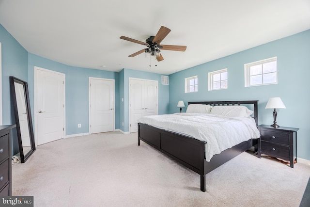 bedroom with baseboards, light carpet, and a ceiling fan