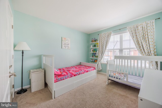 carpeted bedroom with baseboards