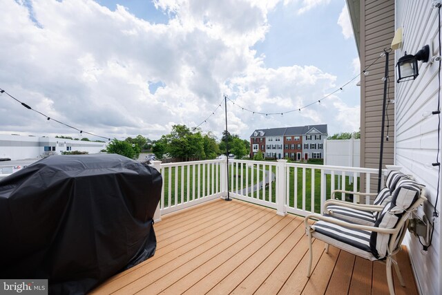 wooden terrace featuring a grill