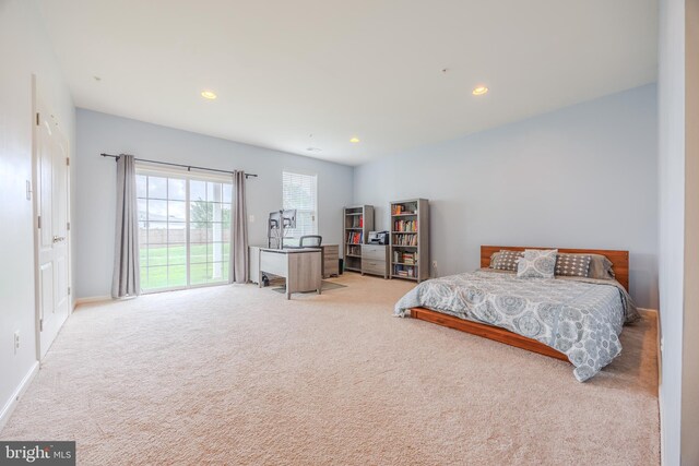 bedroom with light colored carpet, recessed lighting, and baseboards