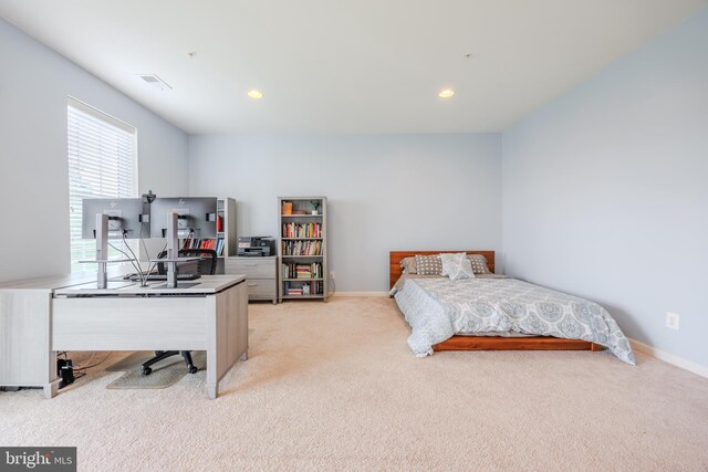bedroom featuring light carpet, a desk, baseboards, and recessed lighting