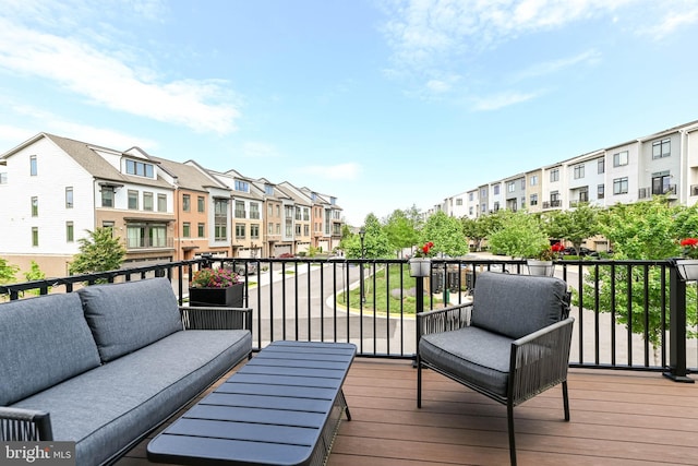 wooden terrace featuring a residential view and an outdoor hangout area