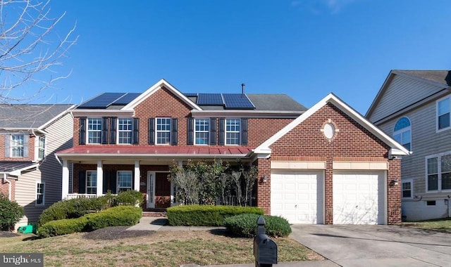 2708 Lake Forest Dr, Upper Marlboro, MD 20774 - traditional-style house featuring brick siding, an attached garage, driveway, covered porch, and roof mounted solar panels