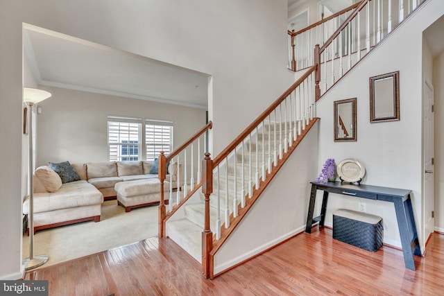 2708 Lake Forest Dr, Upper Marlboro, MD 20774 - stairs featuring wood finished floors, crown molding, and baseboards