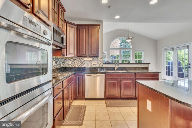 2708 Lake Forest Dr, Upper Marlboro, MD 20774 - kitchen with stainless steel appliances, a sink, lofted ceiling, a ceiling fan, and decorative backsplash