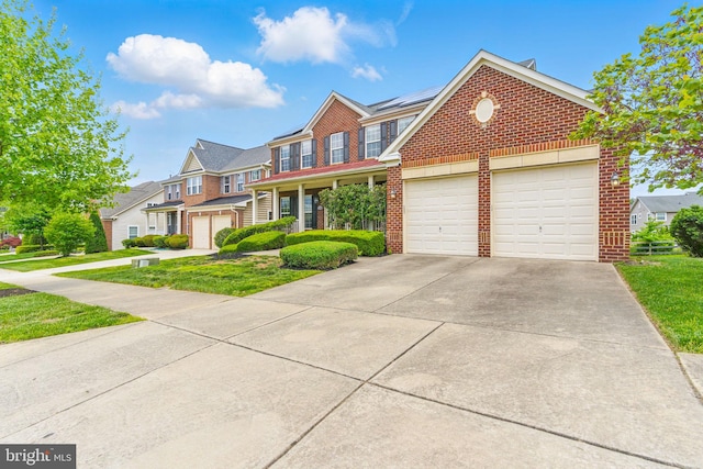 2708 Lake Forest Dr, Upper Marlboro, MD 20774 - view of front facade featuring brick siding, solar panels, driveway, and a front yard