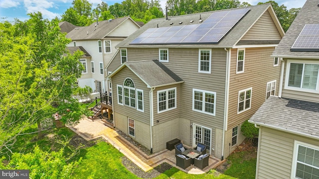 2708 Lake Forest Dr, Upper Marlboro, MD 20774 - back of property with roof mounted solar panels, outdoor lounge area, a patio, a shingled roof, and a wooden deck