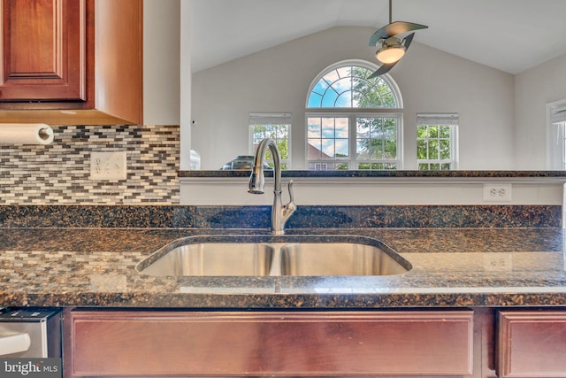 2708 Lake Forest Dr, Upper Marlboro, MD 20774 - kitchen with a sink, backsplash, vaulted ceiling, and dark stone countertops