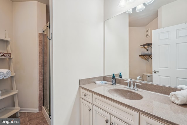 full bathroom featuring toilet, a shower stall, vanity, and tile patterned floors