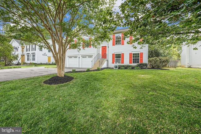 view of front of property featuring driveway, a front yard, and fence