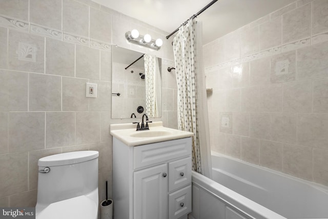 bathroom with tile walls, shower / tub combo with curtain, toilet, and vanity