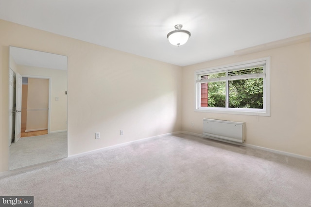 carpeted spare room with baseboards