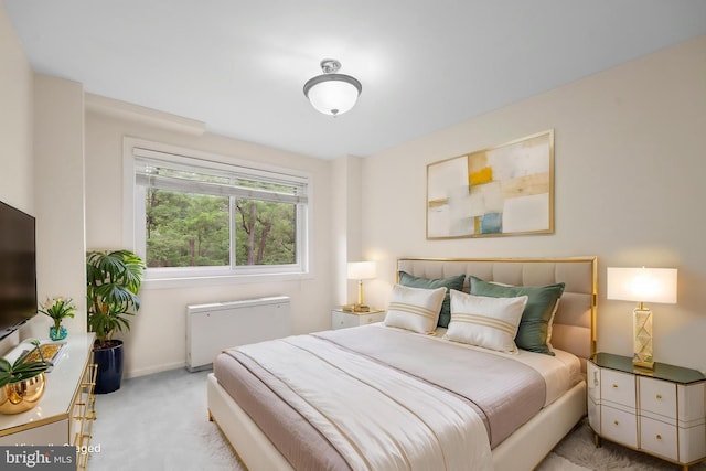 carpeted bedroom featuring radiator and baseboards