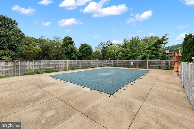 community pool featuring a patio area and fence
