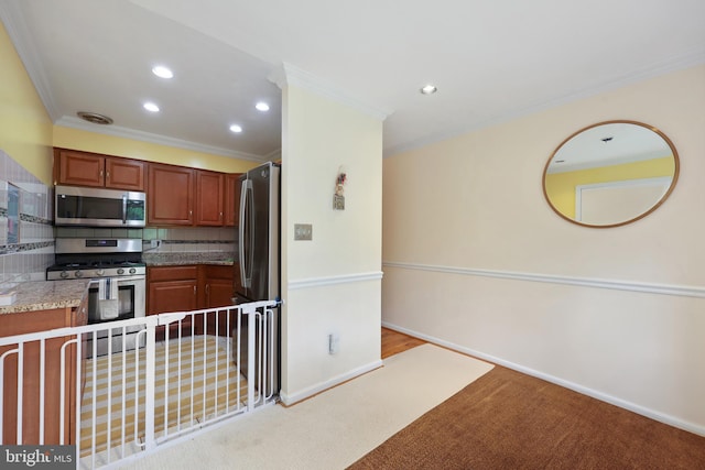 kitchen featuring appliances with stainless steel finishes, crown molding, carpet, recessed lighting, and brown cabinetry