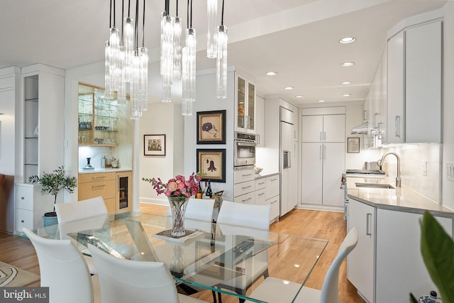 700 New Hampshire Ave NW Unit 507, Washington, DC 20037 - dining space with light wood-type flooring, recessed lighting, wine cooler, and baseboards