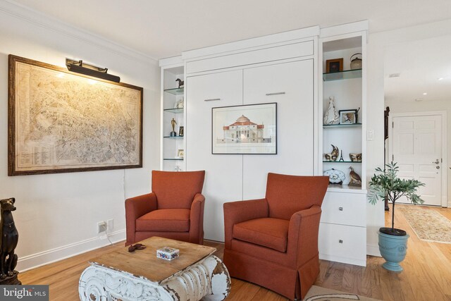 700 New Hampshire Ave NW Unit 507, Washington, DC 20037 - living area with wood finished floors, built in features, ornamental molding, and baseboards