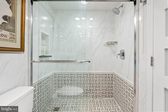 700 New Hampshire Ave NW Unit 507, Washington, DC 20037 - bathroom featuring toilet, tile walls, and a stall shower
