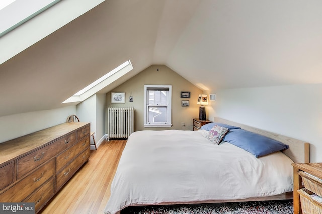 7017 Woodland Ave, Takoma Park, MD 20912 - bedroom featuring radiator heating unit, a skylight, light wood finished floors, and vaulted ceiling